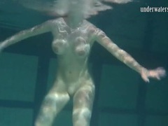 FuckCult presents: Naked brunette with big tits swims solo