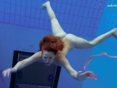 FuckCult presents: Curly hair redhead swims and looks sexy