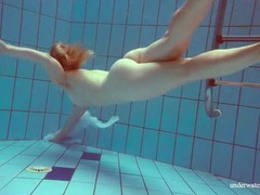 FuckCult presents: Redhead goes for a nude swim in the pool